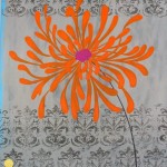 orange flower on damask patterned background